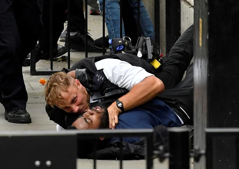 A protester and a police officer clash near Downing Street during a Black Lives Matter protest following the death of George Floyd, who died in police custody in Minneapolis, London, Britain. REUTERS/Toby Melville
